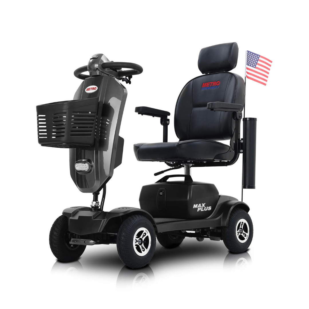 The metro Mobility MAX Plus Scooter, shown in black with a 300W motor, padded seat, armrests, front basket, and an American flag at the back, offers comfort and style with a 16-mile range; displayed on a white background.